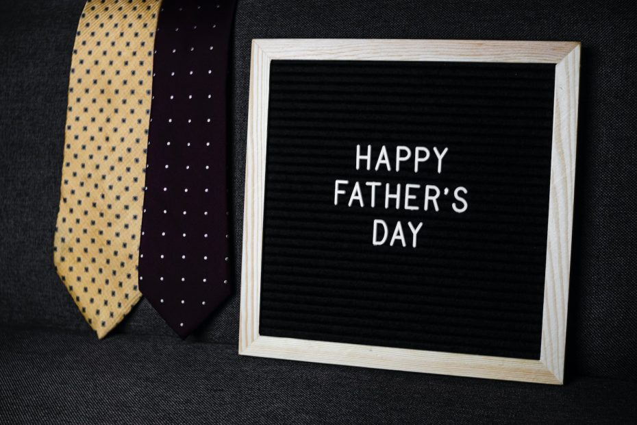 a father's day sign next to two ties